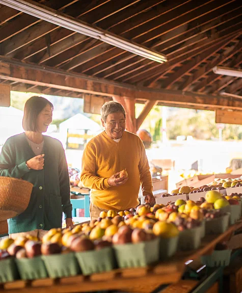 Una pareja comprando productos frescos en Bears Market en Keremeos.