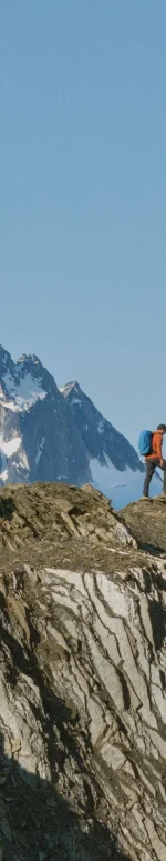 Three friends heli-hiking amongst the glaciers and mountain spires of the Bugaboos with their guide from CMH Bugaboos.