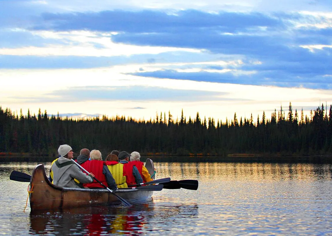 A group of people venturing out on a Northwest Voyageur Company tour at one McGillvray Lake near Sun Peaks Resort