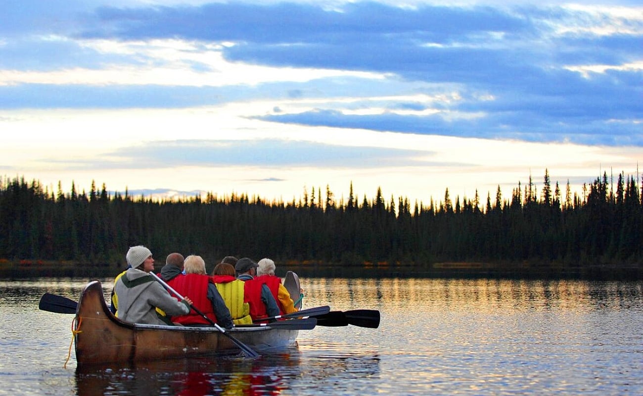 A group of people venturing out on a Northwest Voyageur Company tour at one McGillvray Lake near Sun Peaks Resort