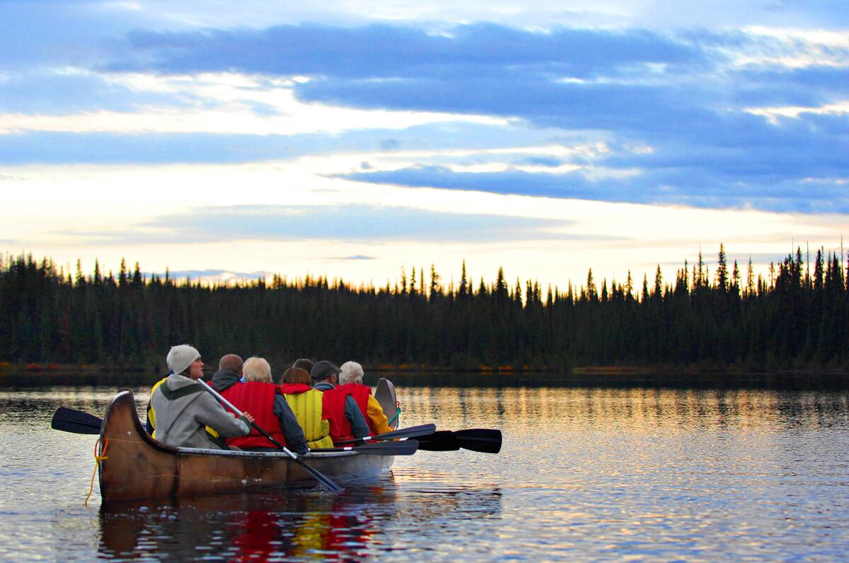 A group of people venturing out on a Northwest Voyageur Company tour at one McGillvray Lake near Sun Peaks Resort