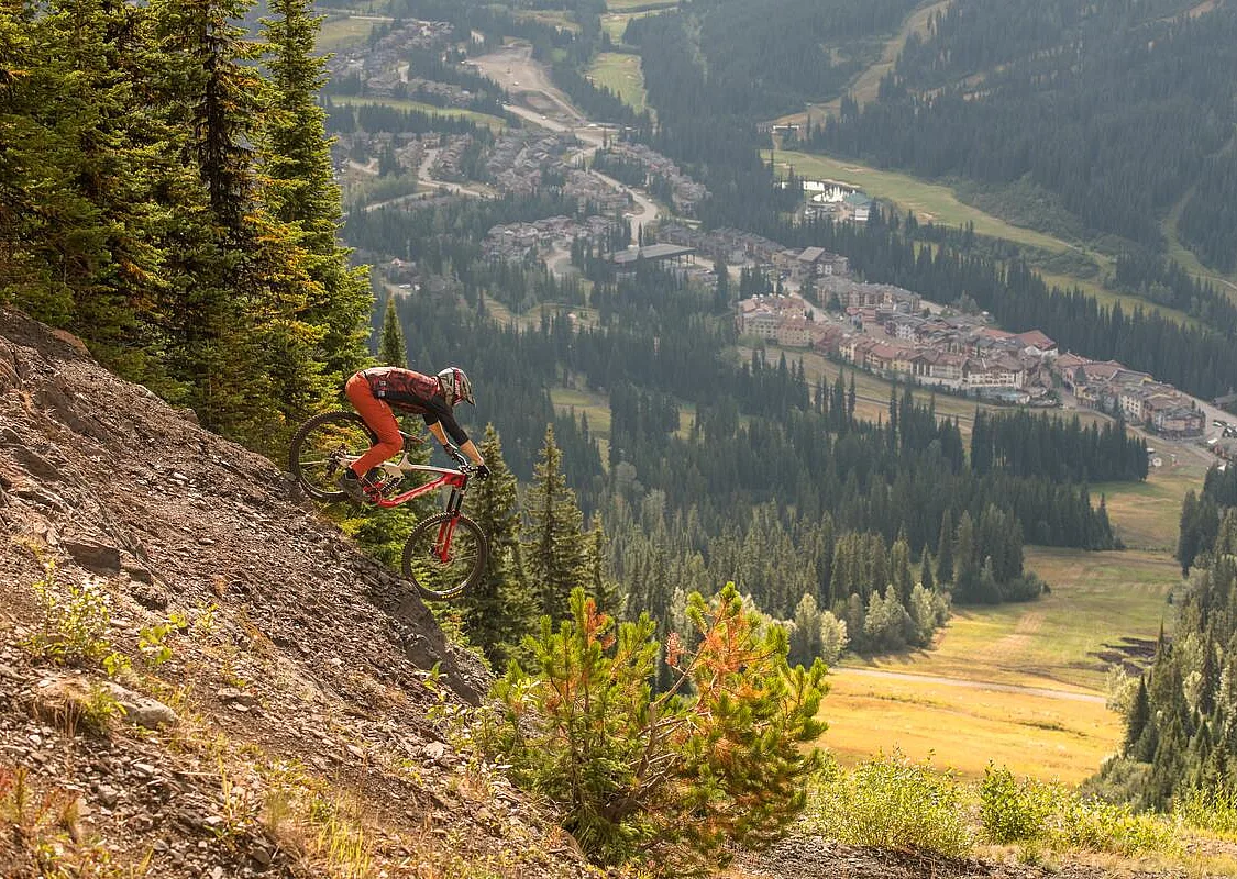 A mountain biker riding at Sun Peaks Bike Park.