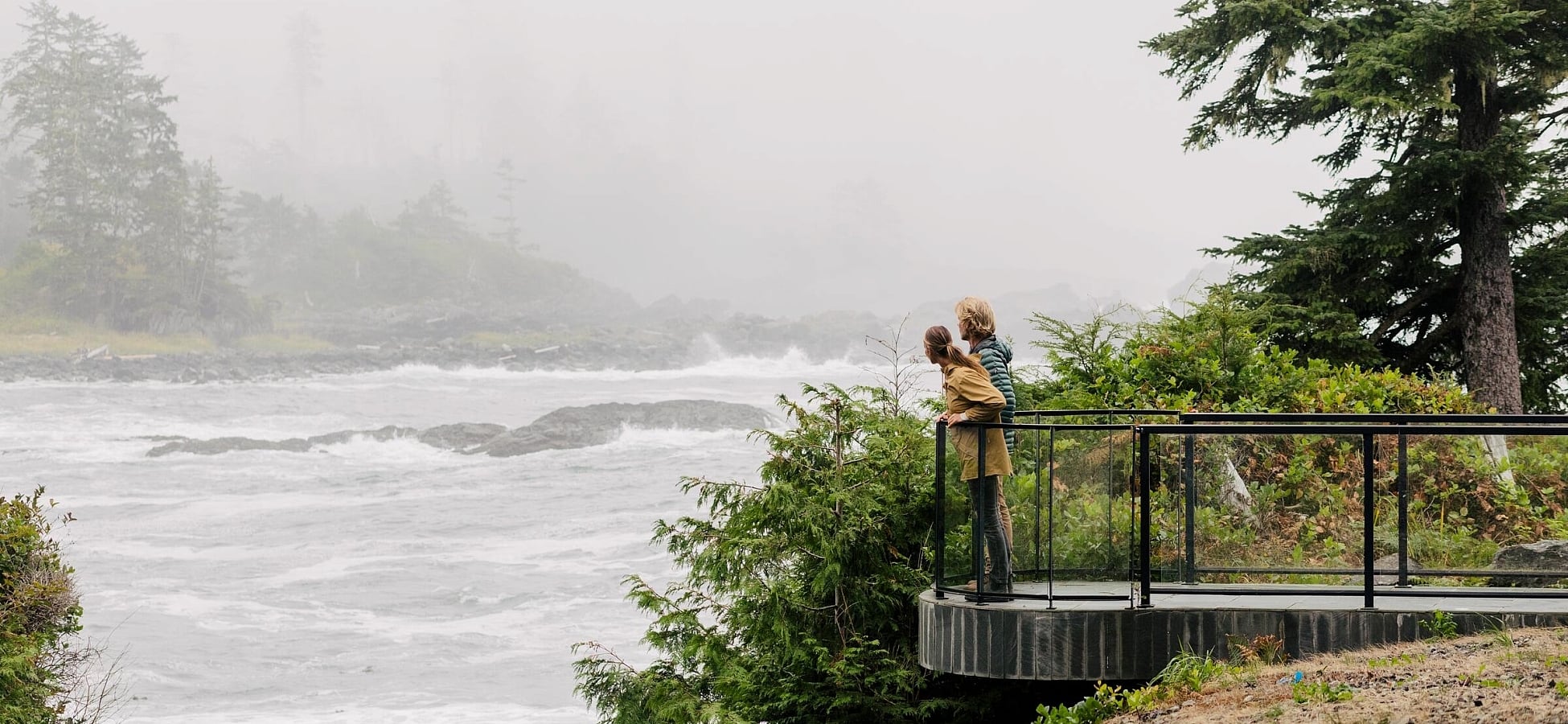 Two people taking in the ocean views at Black Rock Oceanfront Resort in Ucluelet.