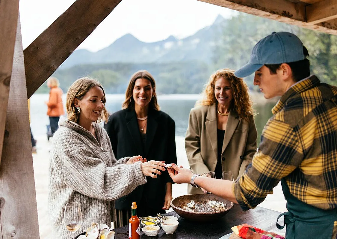 Guests taking part in an outdoor culinary experience at Nimmo Bay Wilderness Resort on Vancouver Island.
