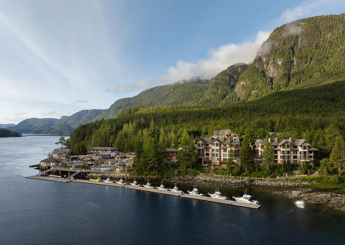 Waterfront view of Sonora Resort surrounded by forested mountains on Sonora Island.