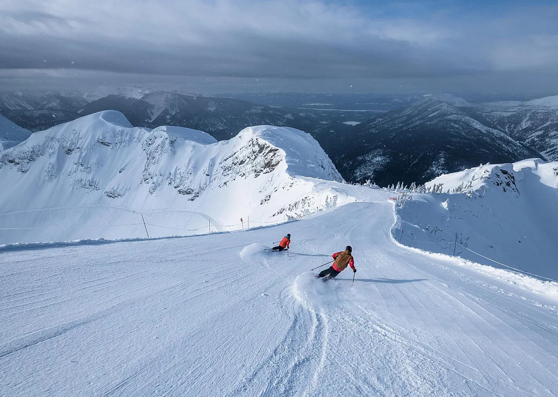 A duo of skiers downhill skiing at Fernie Alpine Resort.