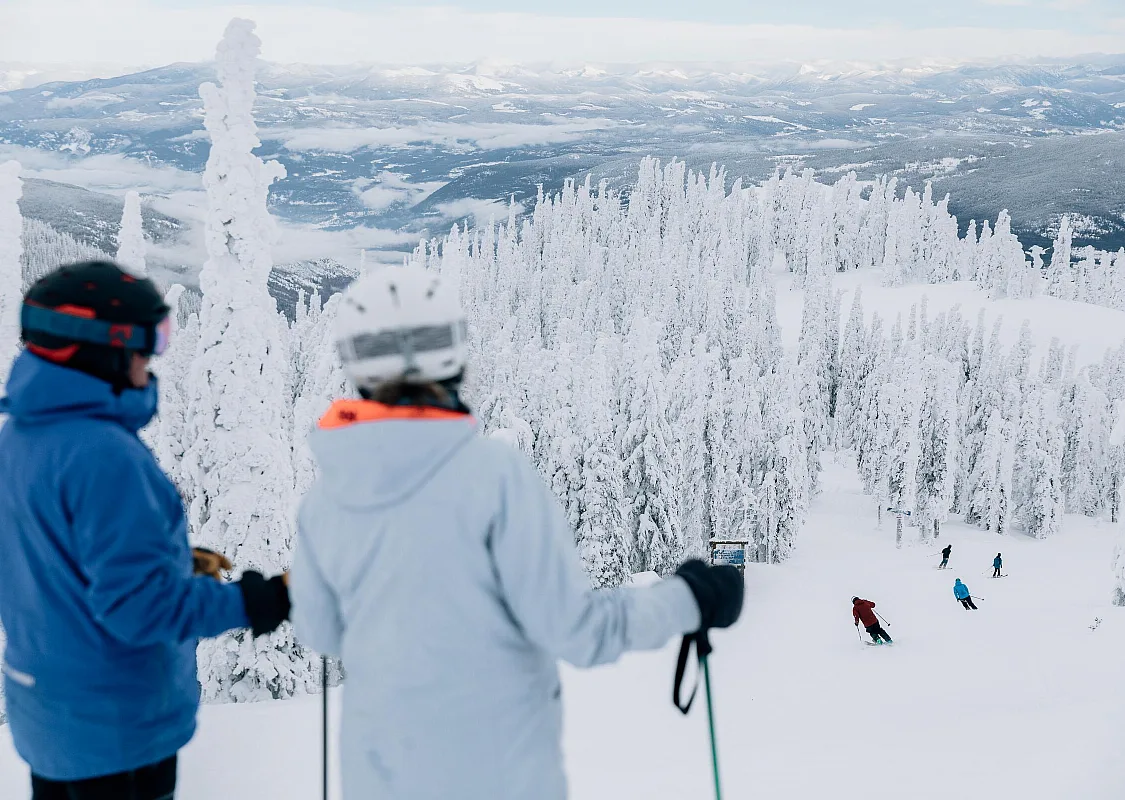 Skiers and snow-covered trees at Red Mountain Resort in Rossland.