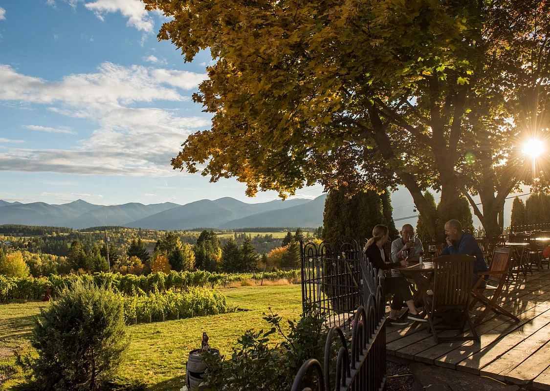 People at the Skimmerhorn Winery & Vineyard enjoy wine on the deck of their bistro in Creston, BC.