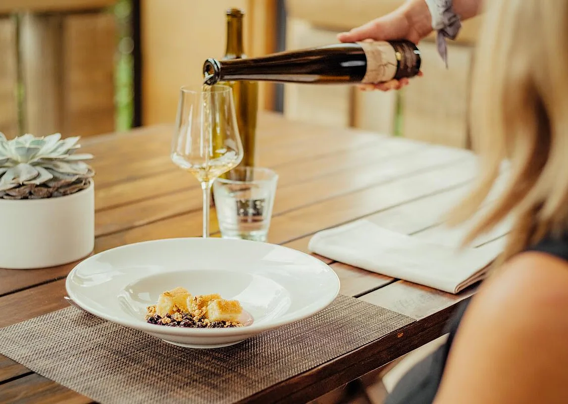 Person dining at Mission Hill Family Estate winery in West Kelowna.
