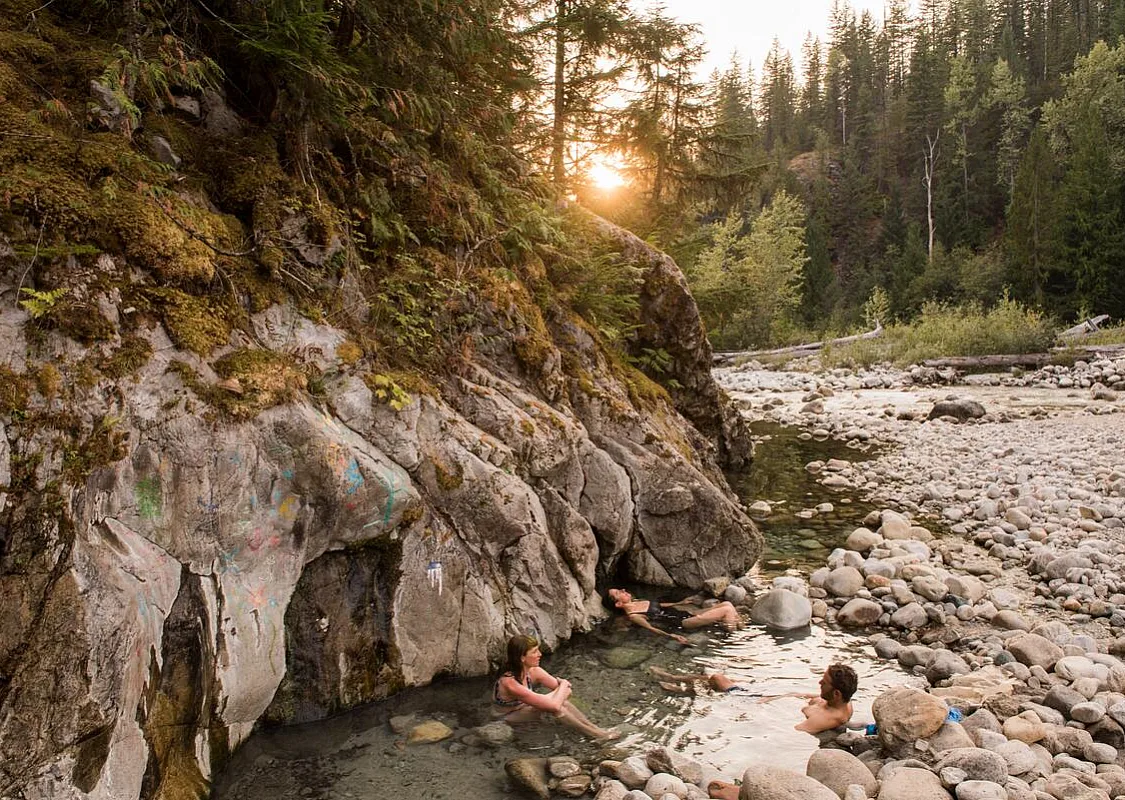 Visitors soak in the lower pools at the Halfway River Hot Springs in Nakusp, BC