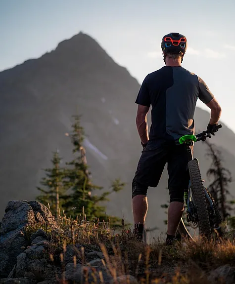 A mountain biker taking a moment to enjoy the view from the Seven Summits Trail in Rossland.