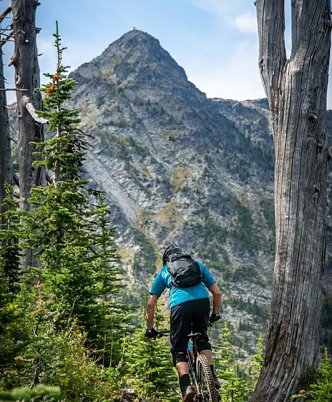 A mountain biker riding the Seven Summits Trail in Rossland.