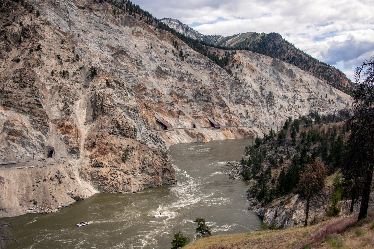 An aerial view of a group river rafting on the Thompson River during their stay at Kumsheen Rafting Resort in Lytton.