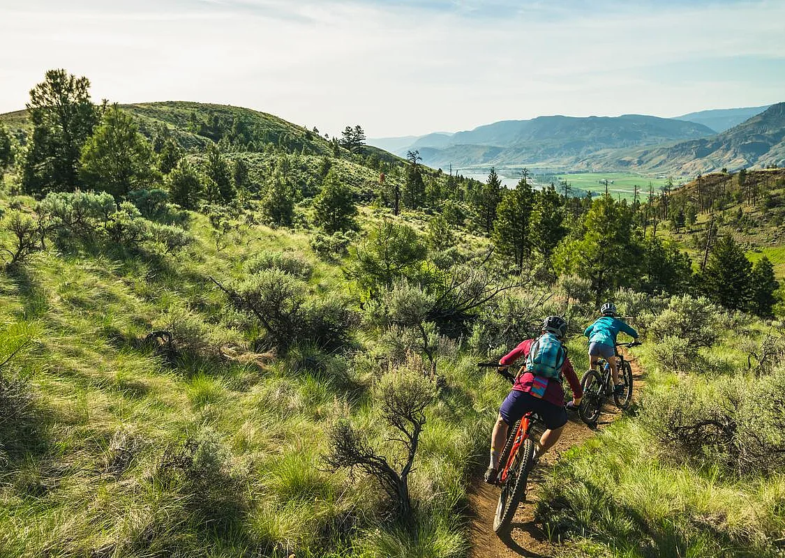 Two people mountain biking at Kenna Cartwright Nature Park in Kamloops.