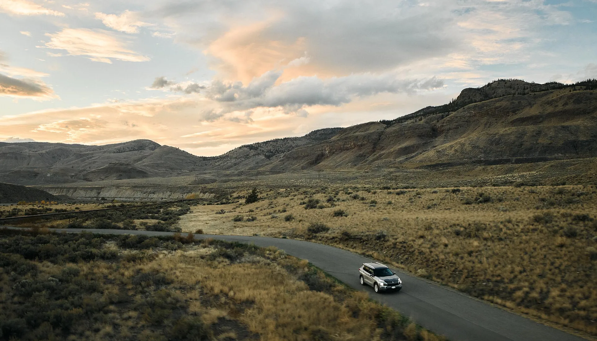 Vehicle driving along the Thompson River near Juniper Beach Provincial Park between Kamloops and Cache Creek.